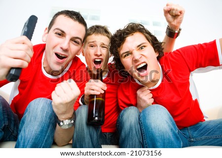 stock-photo-three-happy-men-sitting-on-couch-and-watching-sport-on-tv-21073156.jpg