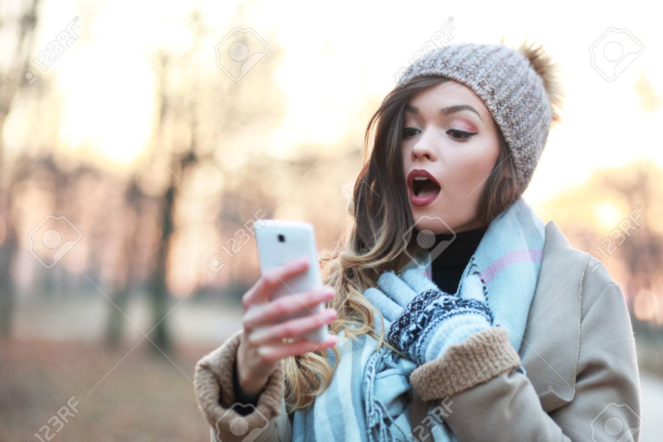 71558770-shocked-girl-looking-at-smartphone-screen-amazed-and-excited.jpg