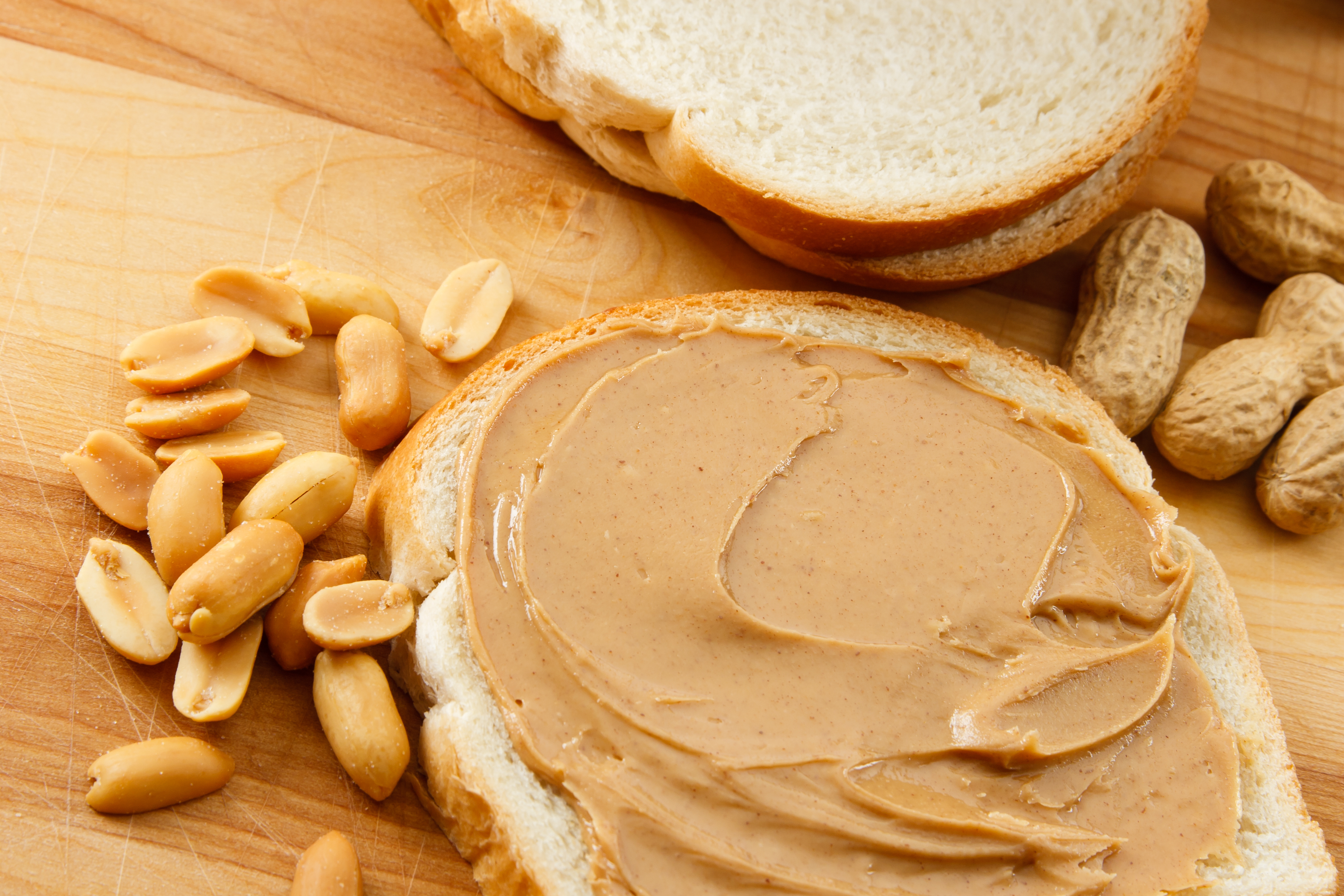 bigstock-peanut-butter-on-bread-with-pe-13614866.jpg